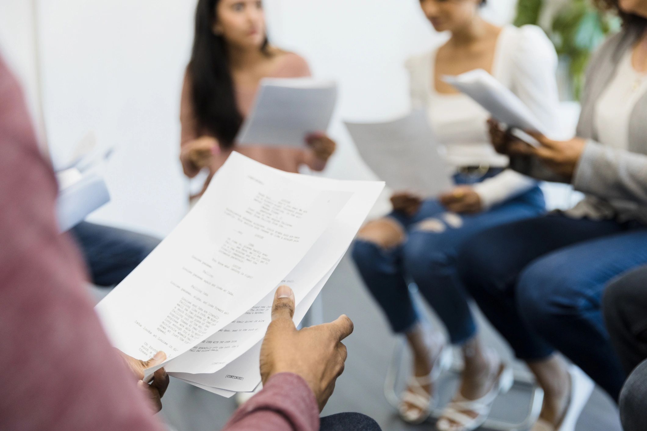 Actors reviewing a script during rehearsal
